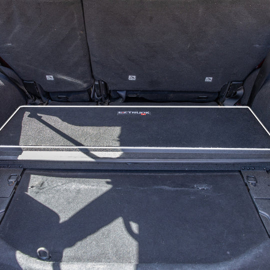 Black carpet mat with 'EZ Trunk' logo installed.
