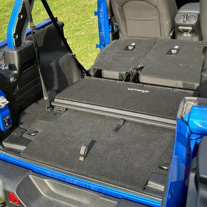 EZTrunk black tailgate carpet installed in blue Jeep, providing custom-fit, durable protection and enhanced cargo area style.