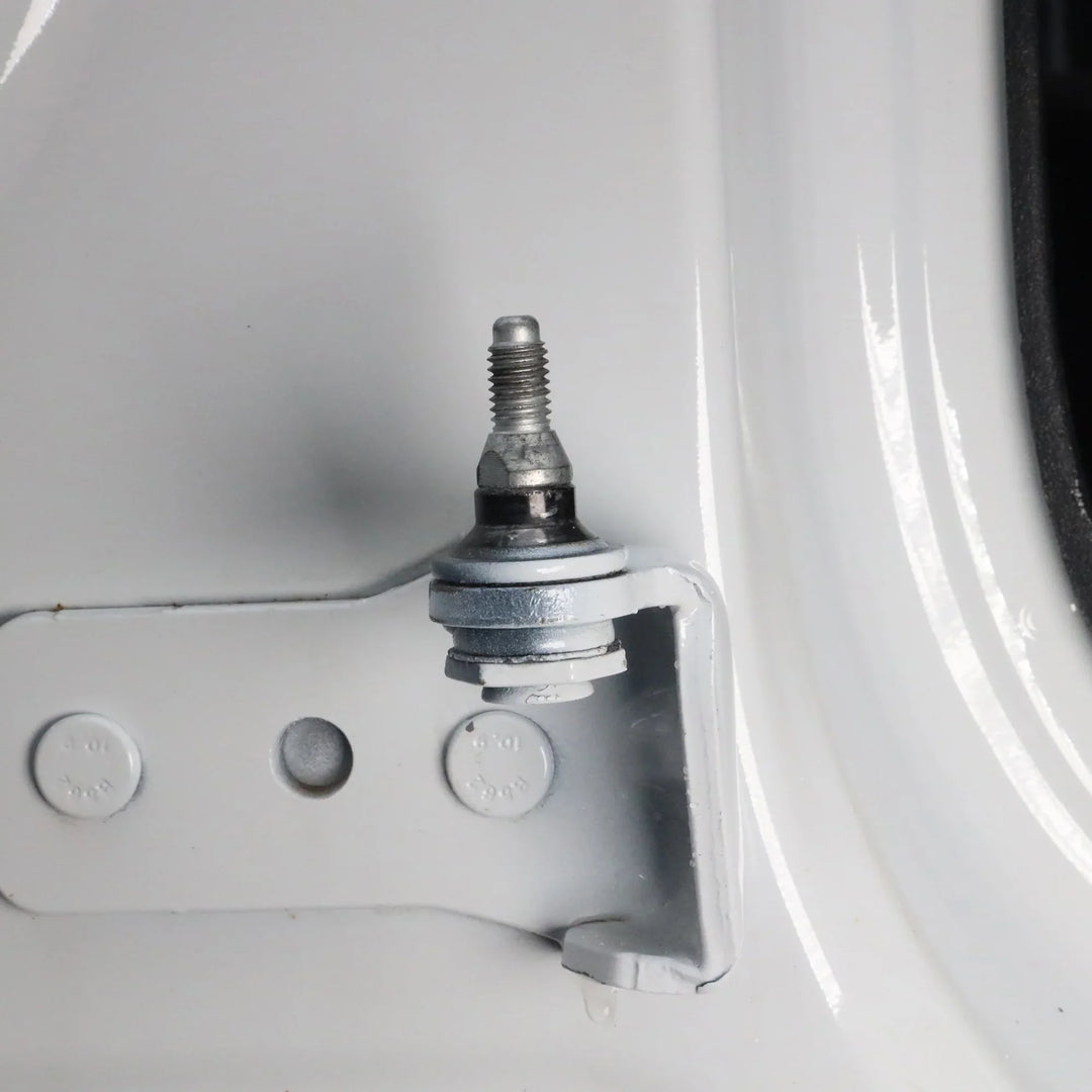 Close-up of fully installed door alignment pin in Ford Bronco hinge, showing correct final position and proper alignment.