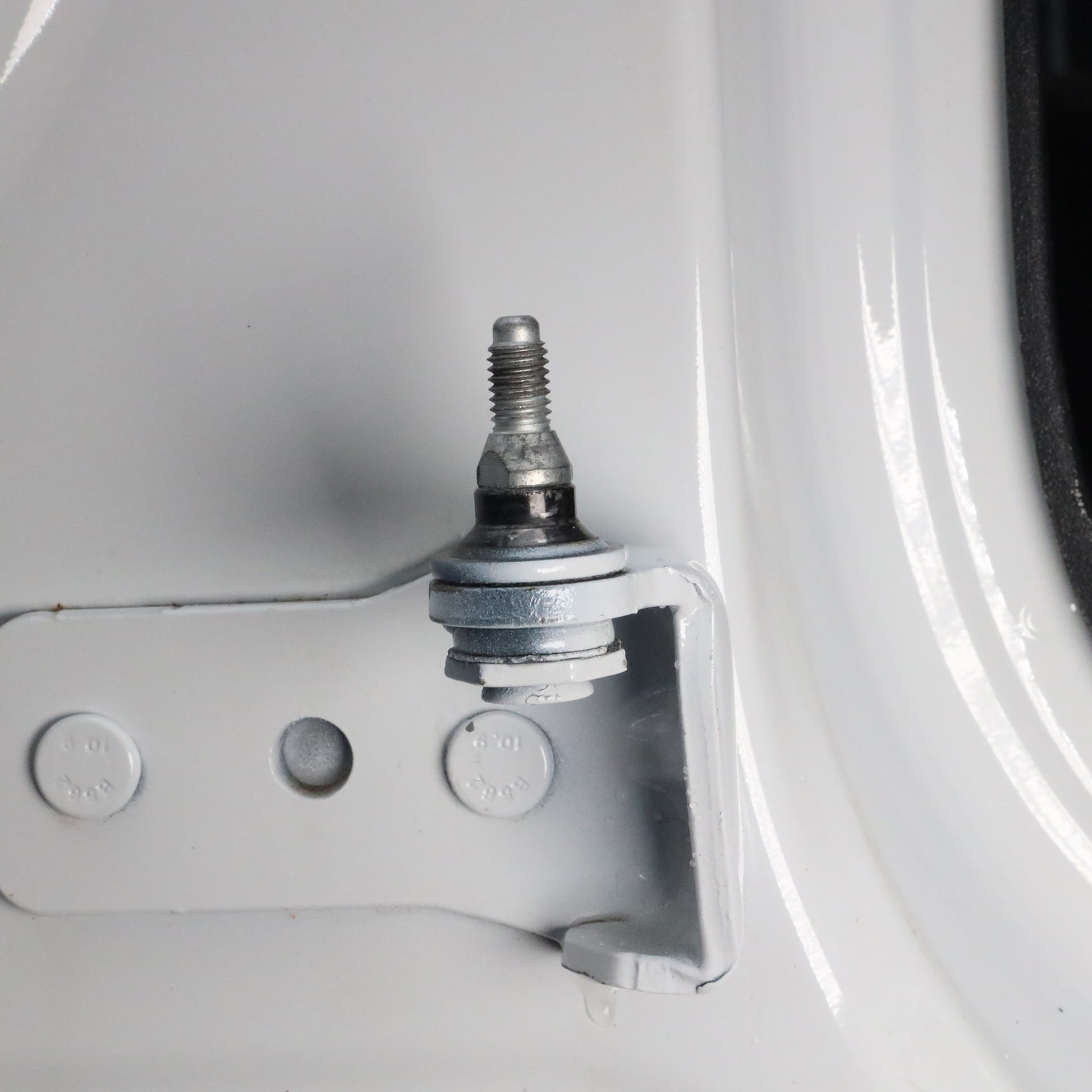 Close-up of fully installed door alignment pin in Ford Bronco hinge, showing correct final position and proper alignment.