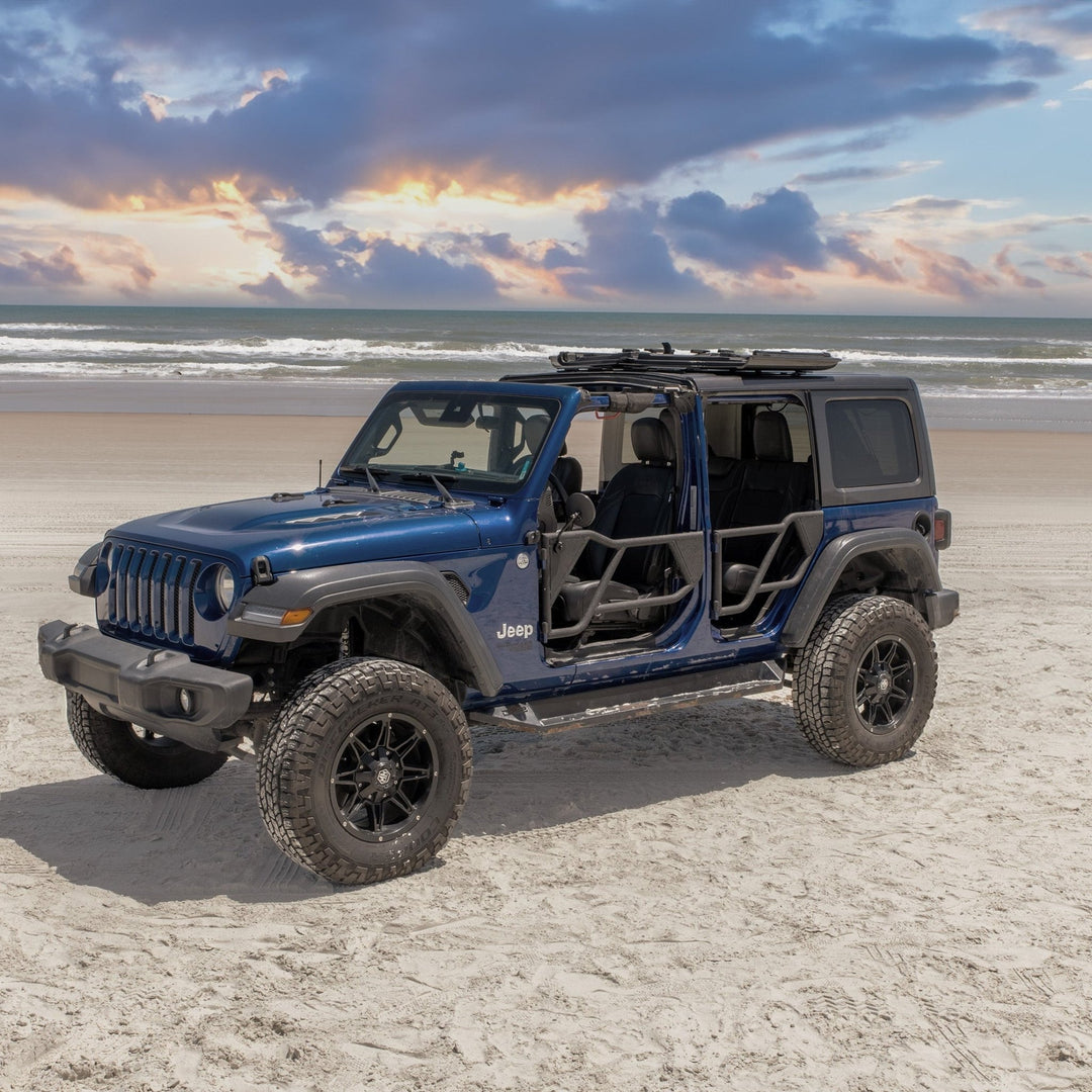 Blue Jeep with EZ4X4 black Razor half-tube aluminum doors installed on a beach, showcasing rugged, open-air design.