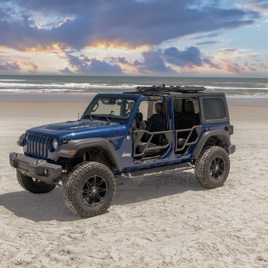 Blue Jeep with EZ4X4 black Razor half-tube aluminum doors installed on a beach, showcasing rugged, open-air design.