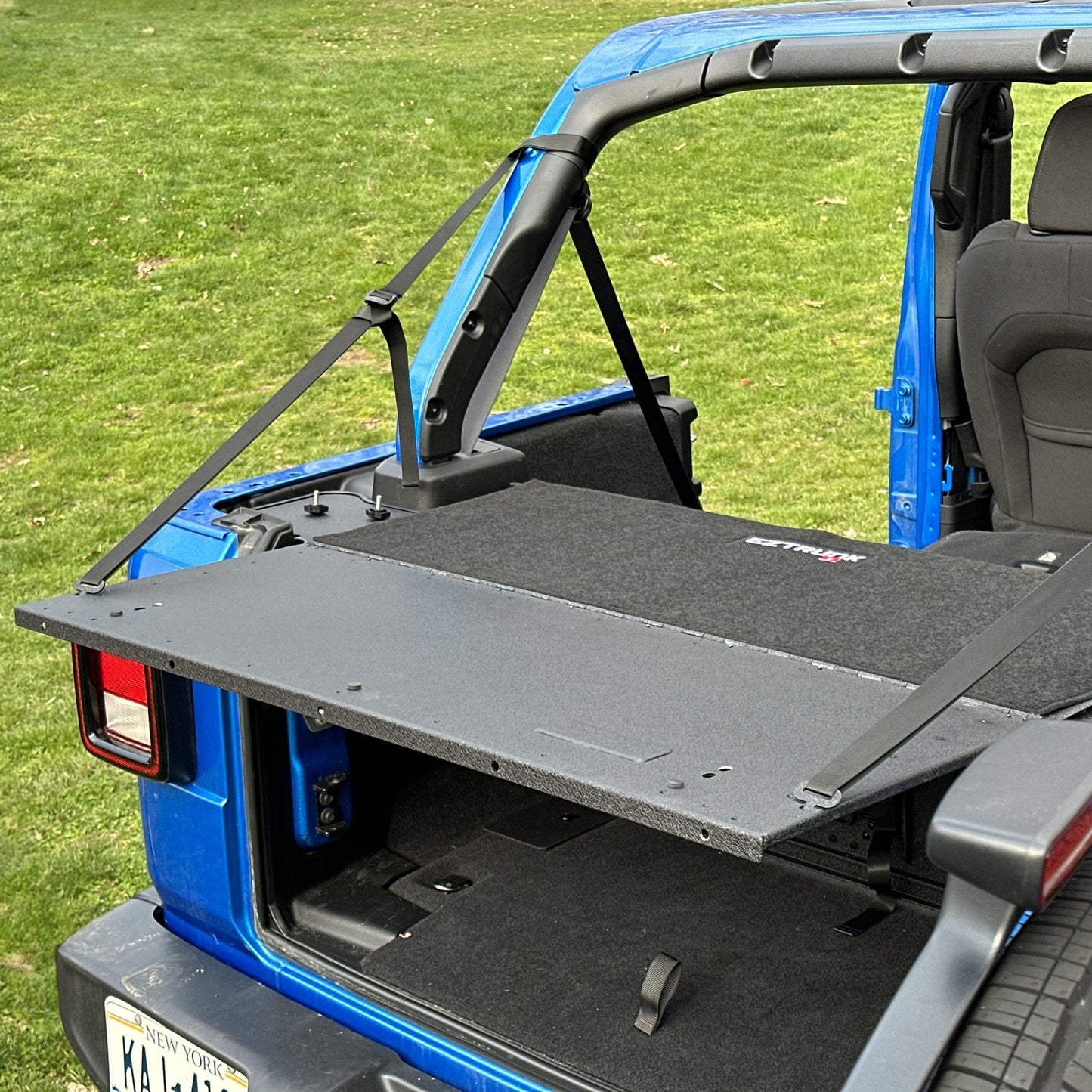 Finished custom carpet kit neatly fitted outside EZ trunk, showcasing clean edges and durable interior protection.