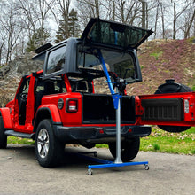 EZ4x4 hardtop lift removing Jeep Wrangler roof, shown above red vehicle for safe, one-person roof removal and storage.