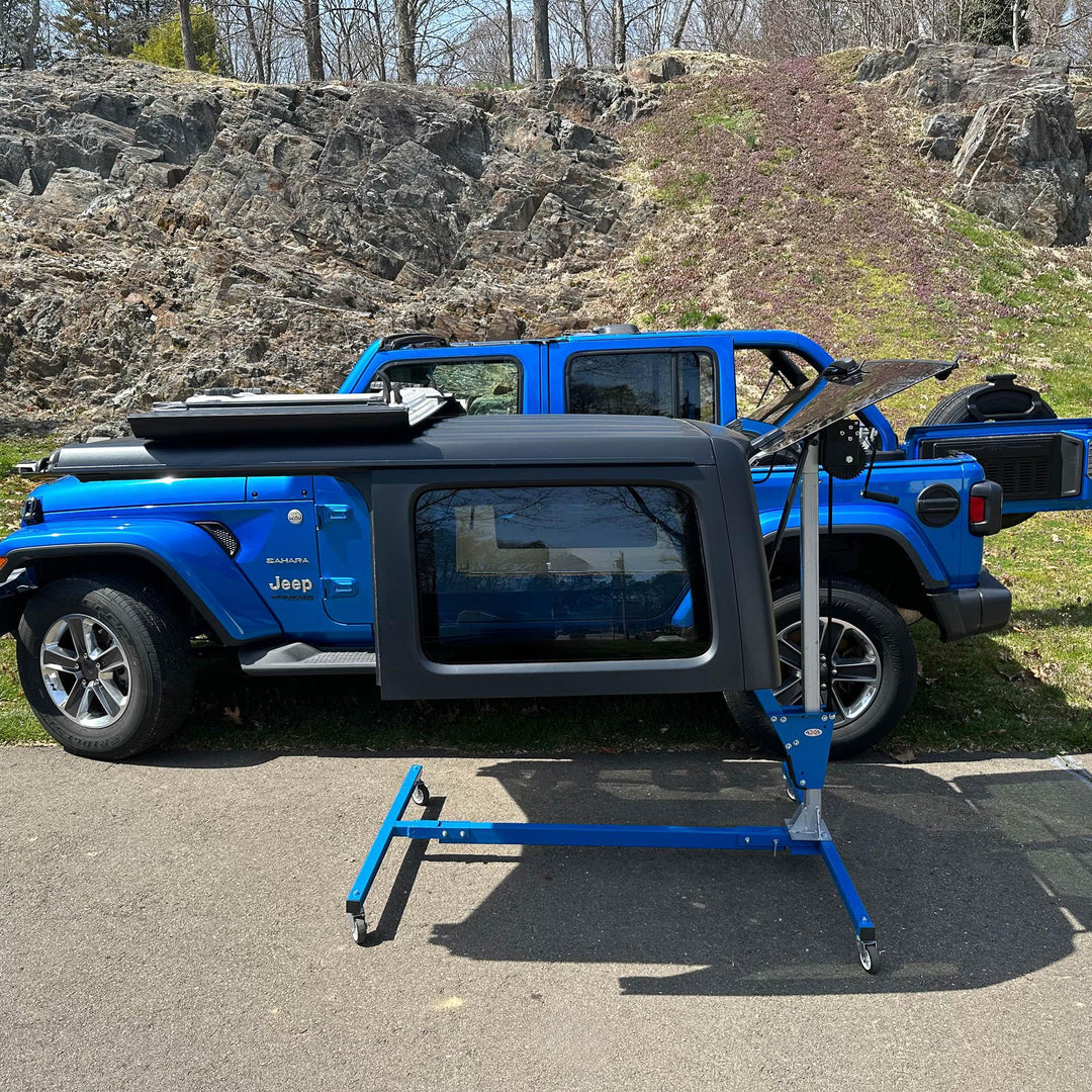 EZ4x4 blue steel hardtop lift holding Jeep top low, showing flexible height adjustment for easy alignment and use.