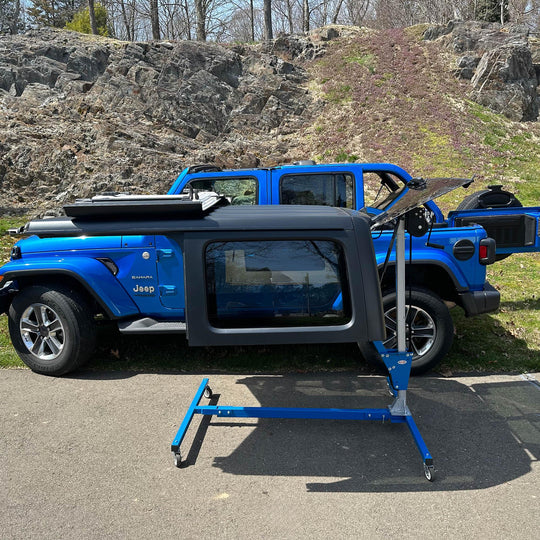 EZ4x4 blue steel hardtop lift holding Jeep top low, showing flexible height adjustment for easy alignment and use.