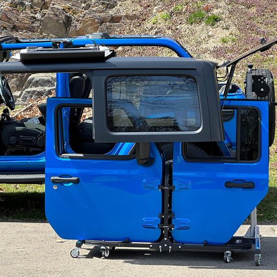 EZ4x4 Hardtop Lift securely holding Jeep Wrangler hardtop next to door cart; blue Jeep shown with roof removed.