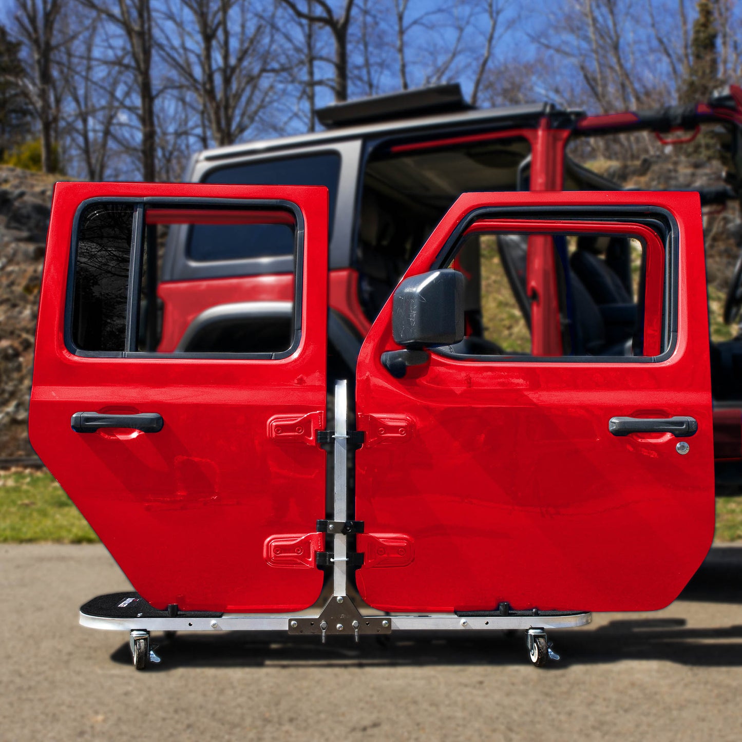 Red Jeep doors stored on EZ4X4 aluminum rolling door cart, showcasing sturdy, portable, space-saving storage solution.