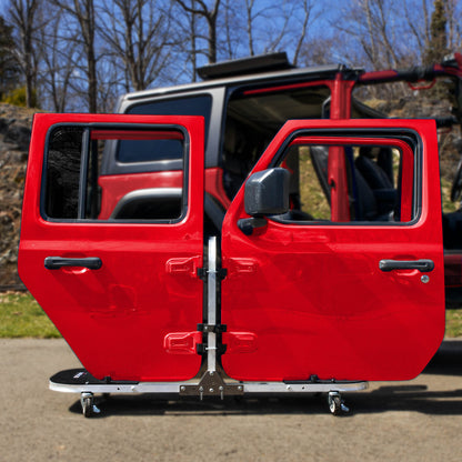 Red Jeep doors stored on EZ4X4 aluminum rolling door cart, showcasing sturdy, portable, space-saving storage solution.