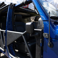 Rectangular aluminum side mirror folded up on blue Jeep, showcasing durable aftermarket design and off-road readiness.