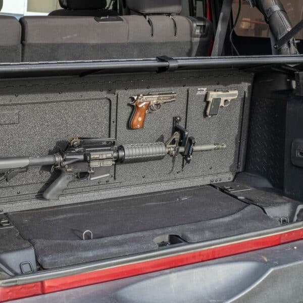 Firearms secured in Jeep trunk with gun mount, highlighting discreet, durable storage for off-road and travel use.