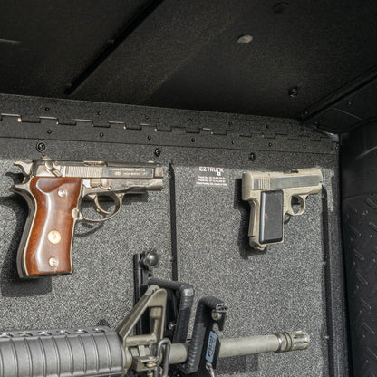 Close-up view of the EZTRUNK storing multiple firearms secured with EZ4X4 gun magnets and mounted gun holders inside the vehicle’s cargo area.