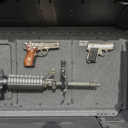Head-on view of the EZTRUNK storing multiple firearms secured with EZ4X4 gun magnets and mounted gun holders inside the vehicle’s cargo area.