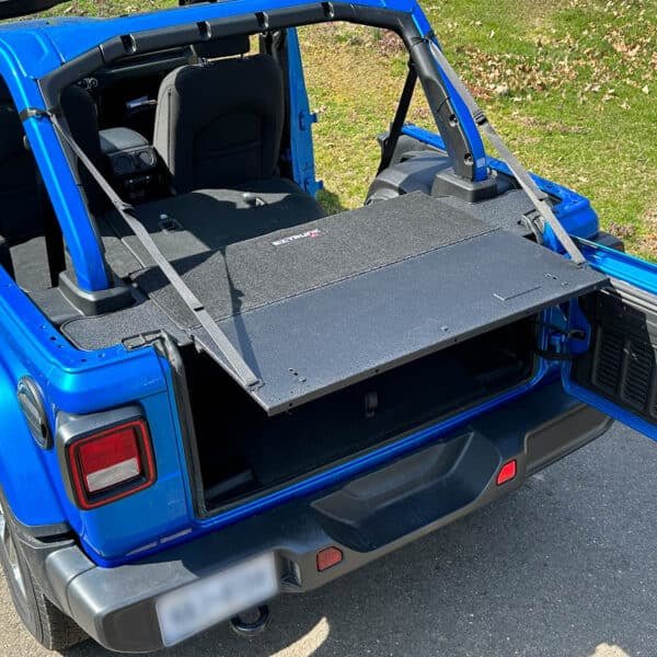 Overhead view of EZTrunk Tailgate Extension Table fully set up in blue Jeep, showing outdoor functionality.