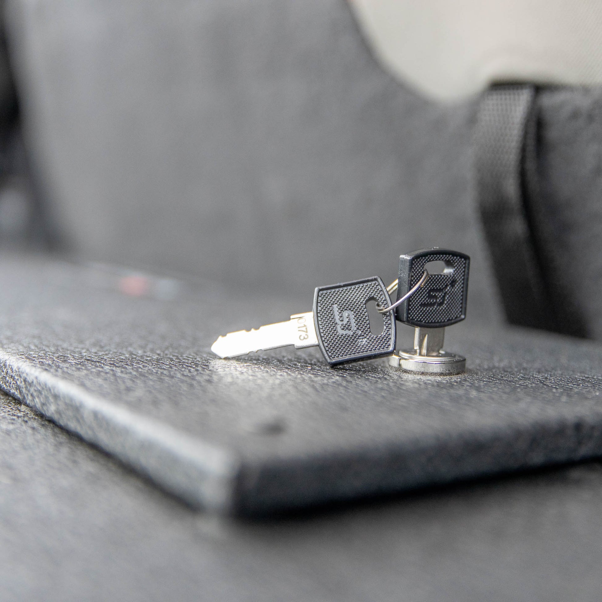 Close-up of black and silver locking keys for EZTrunk top, showing secure locking mechanism and durable construction.