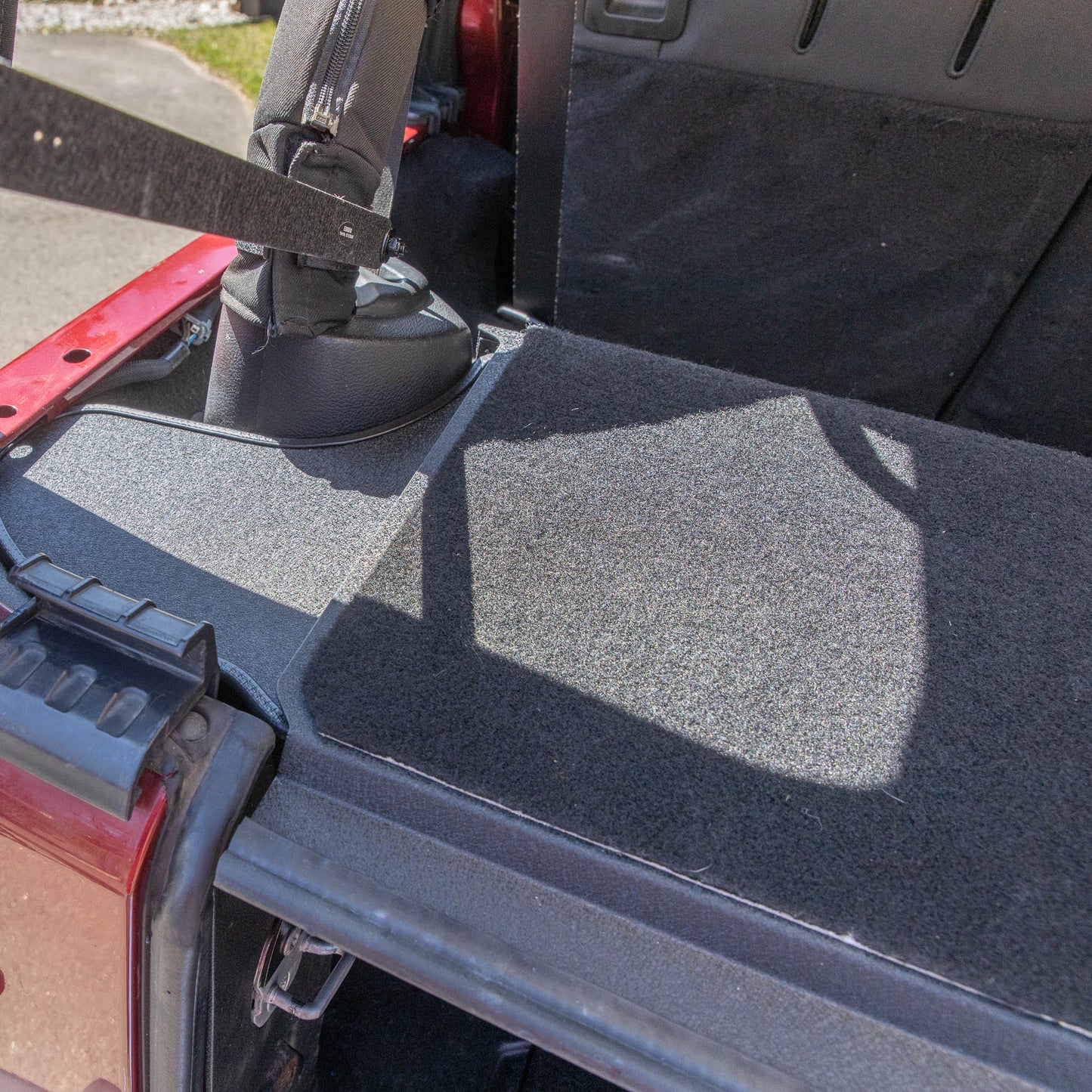 Overhead view of carpeted EZTrunk installed in Jeep, showing top surface and secure fit in cargo area.