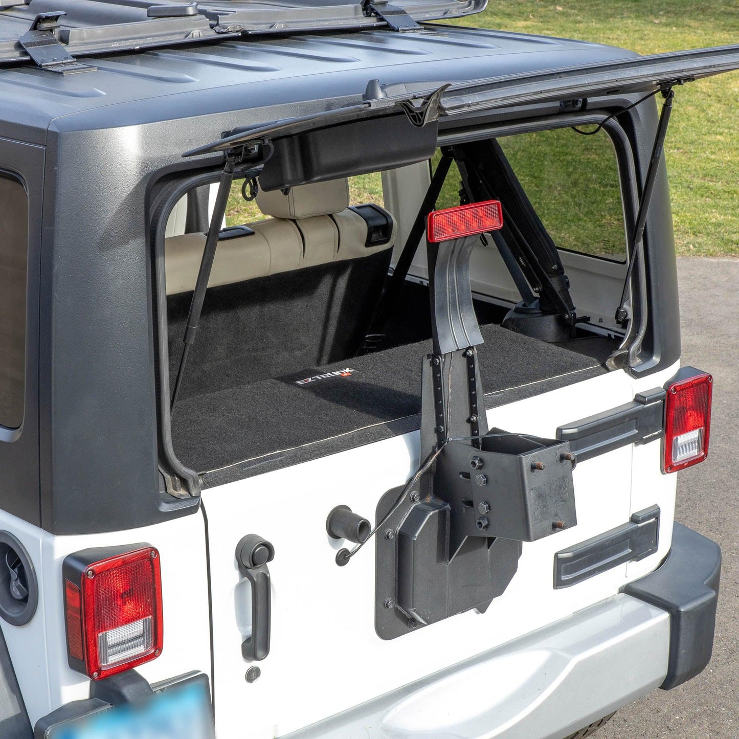 Side view of white Jeep with trunk closed and EZTrunk securely installed inside, showing clean, secure cargo setup.