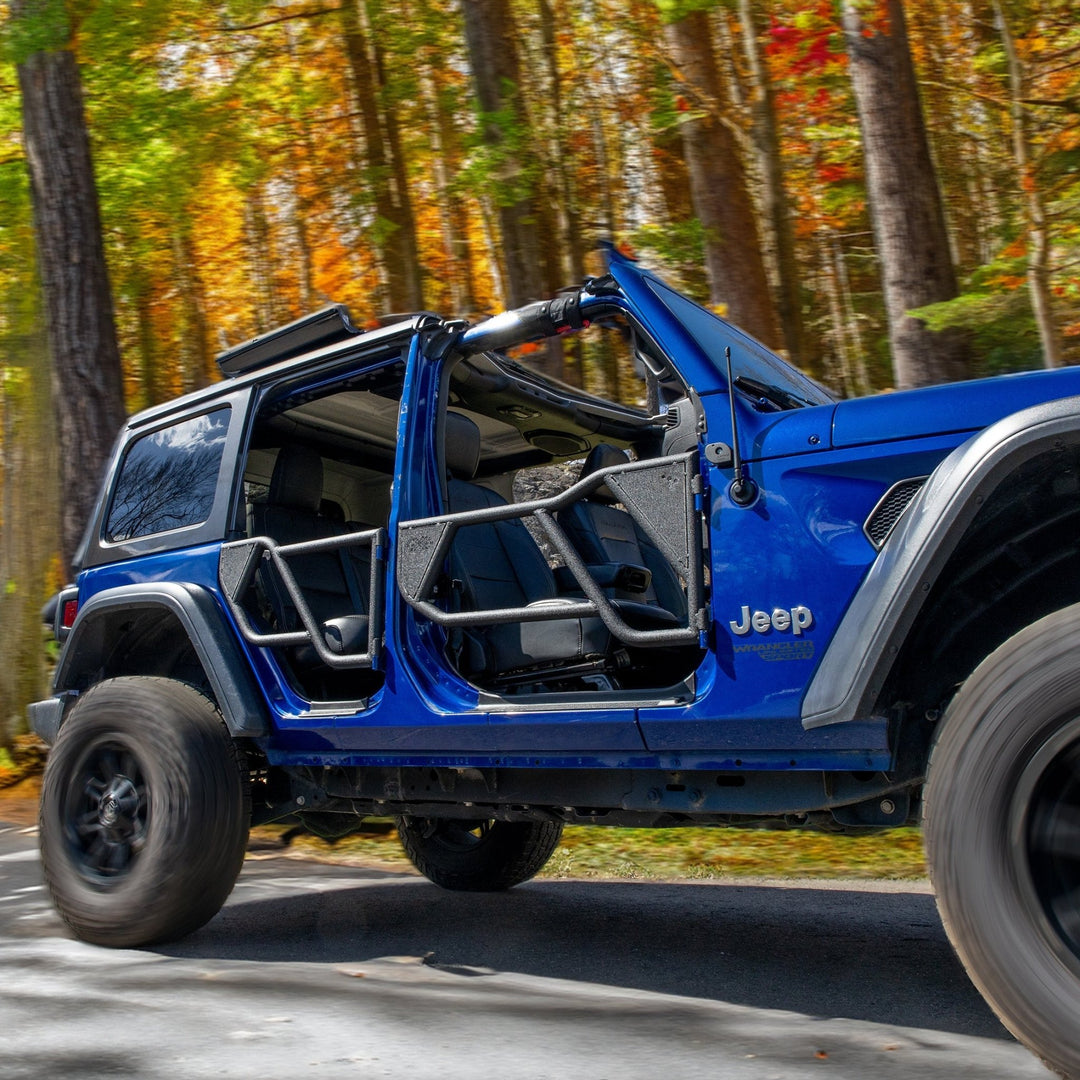 Blue Jeep with EZ4X4 Razor half-tube doors driving through fall forest, highlighting design and open-air off-road style.