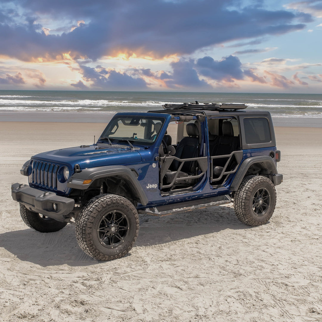 Blue Jeep Wrangler equipped with EZ4X4 black Razor half-tube aluminum doors for off-road use on a sandy beach.