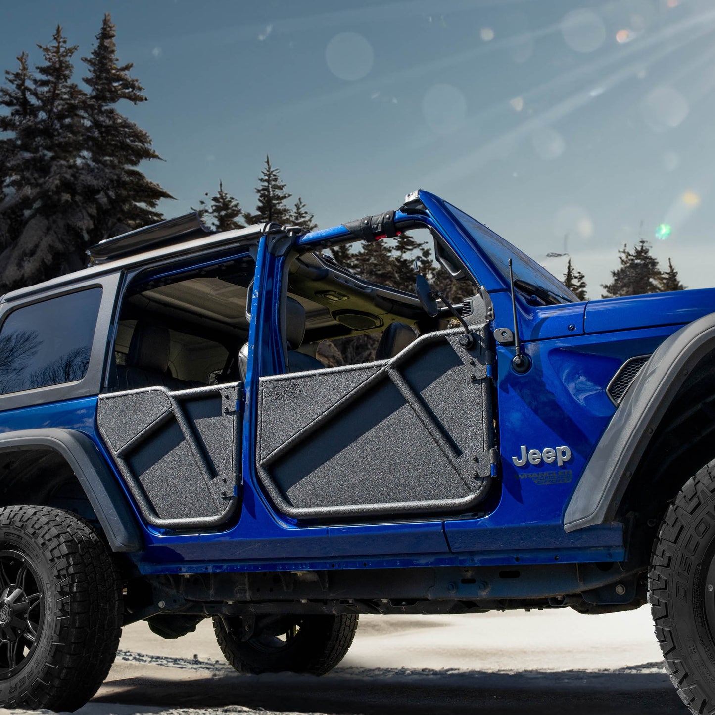 Blue Jeep with black Phantom aluminum doors and all-weather panels installed, showcasing its removable trail-ready design.