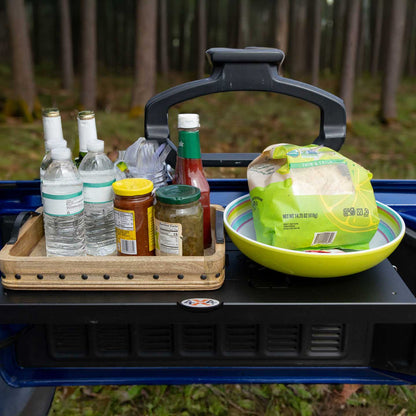 Close-up view of EZ4X4 Single Level Tailgate Table mounted on a Jeep, fully deployed and holding food and drinks.