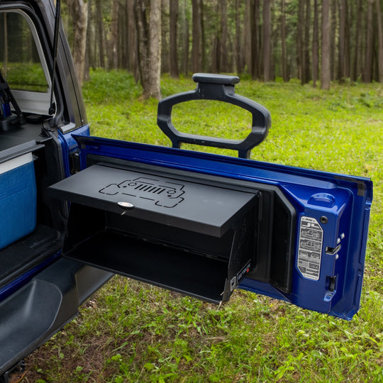 Foldable cargo shelf rack on blue Jeep Wrangler tailgate—portable, space-saving design for overlanding and tailgating.