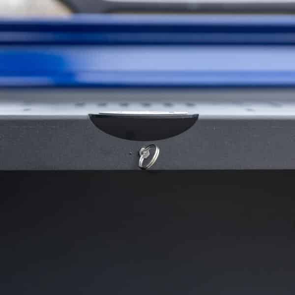Close-up of key ring on black foldable Jeep tailgate table, highlighting sturdy design, utility, and space-saving storage.