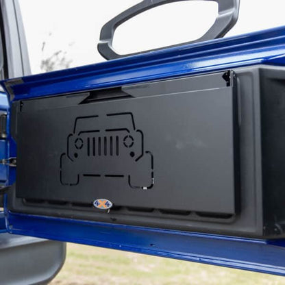 Tailgate table installed on Jeep shown folded up, highlighting space-saving design ideal for off-roading and camping.