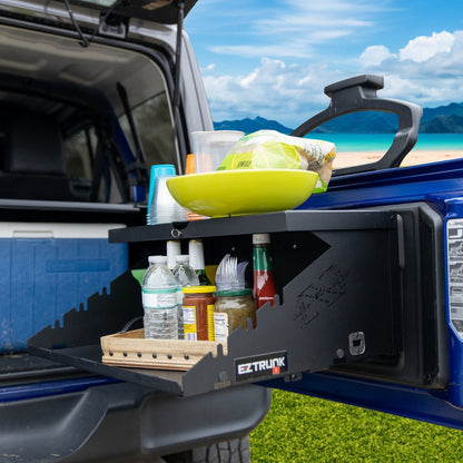 Extreme Folding Tailgate in blue Jeep holding condiments, utensils, food, and drinks for outdoor or tailgating use.