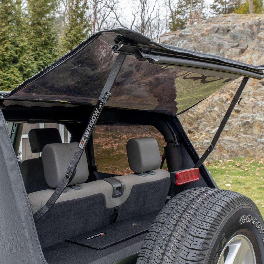 Alternate angle of EZ4X4 EZWindow holding up Jeep soft top rear window, showing improved ventilation and rear cargo access.