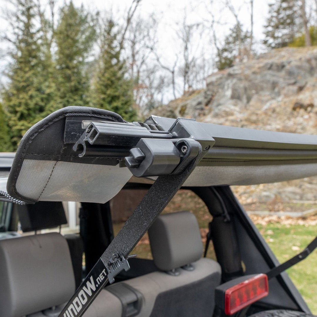 Close-up side angle of EZWindow bolt system attached to Jeep soft top, showing secure mounting and durable hardware.
