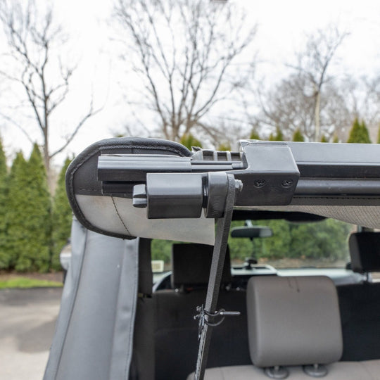 Close-up front view of EZWindow bolt system attached to Jeep soft top, showing secure mounting and durable hardware.
