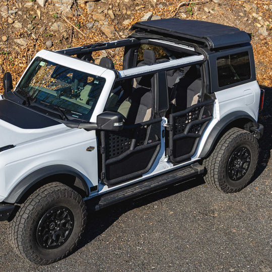 White Ford Bronco equipped with EZ4X4 black Alpha Tube Doors, all-weather panels, and the EZ4X4 Middle Panel Roof Rack Holder.