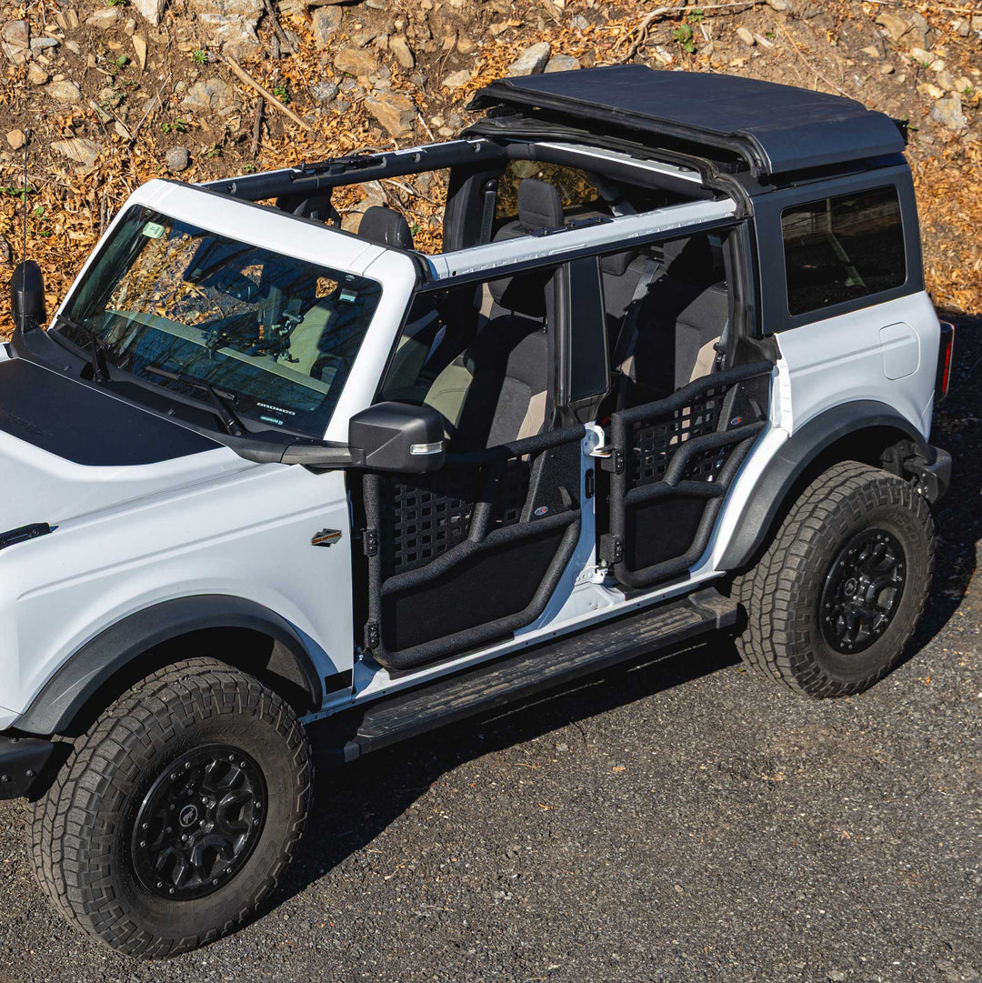 White Ford Bronco equipped with EZ4X4 black Alpha Tube Doors, all-weather panels, and the EZ4X4 Middle Panel Roof Rack Holder.
