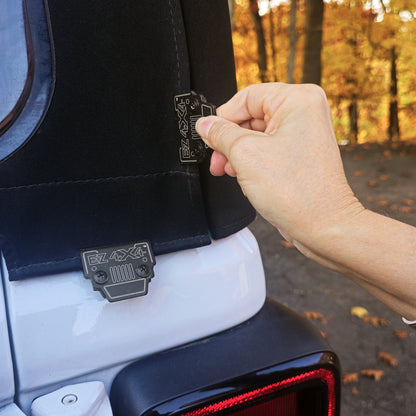 Person installing an aftermarket soft top clip on a Jeep Wrangler, showing secure attachment of the soft top.