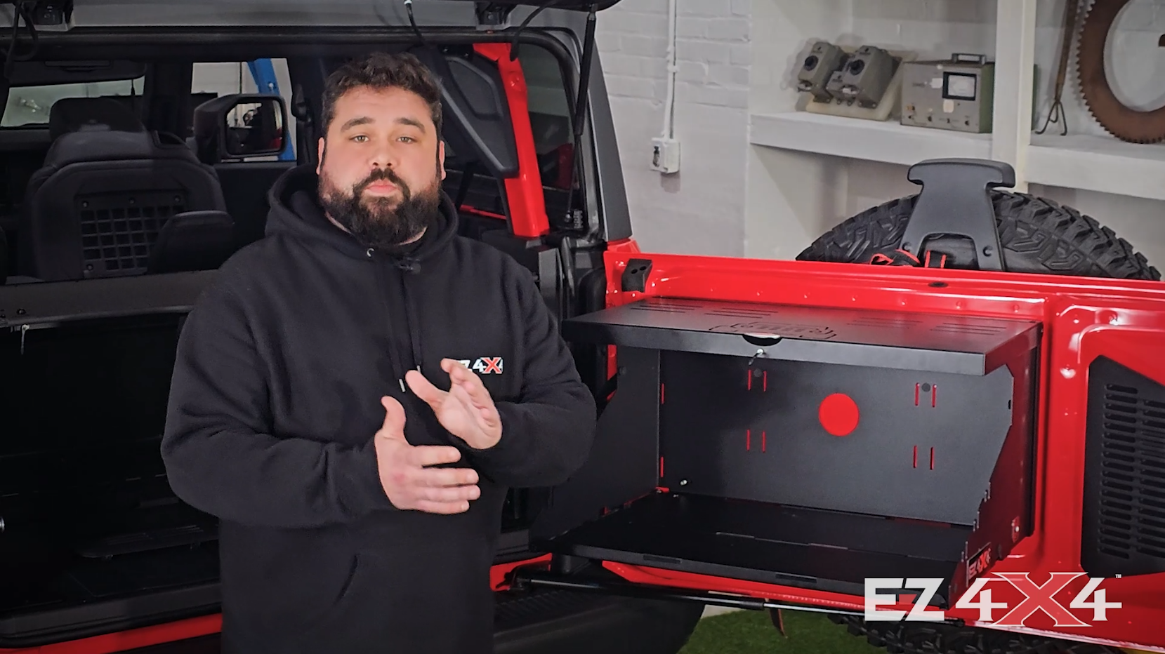 Short video showing the EZ4X4 Extreme Tailgate Table installed on a red Ford Bronco, demonstrated by a person wearing an EZ4X4 hoodie.