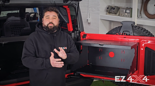 Short video showing the EZ4X4 Extreme Tailgate Table installed on a red Ford Bronco, demonstrated by a person wearing an EZ4X4 hoodie.
