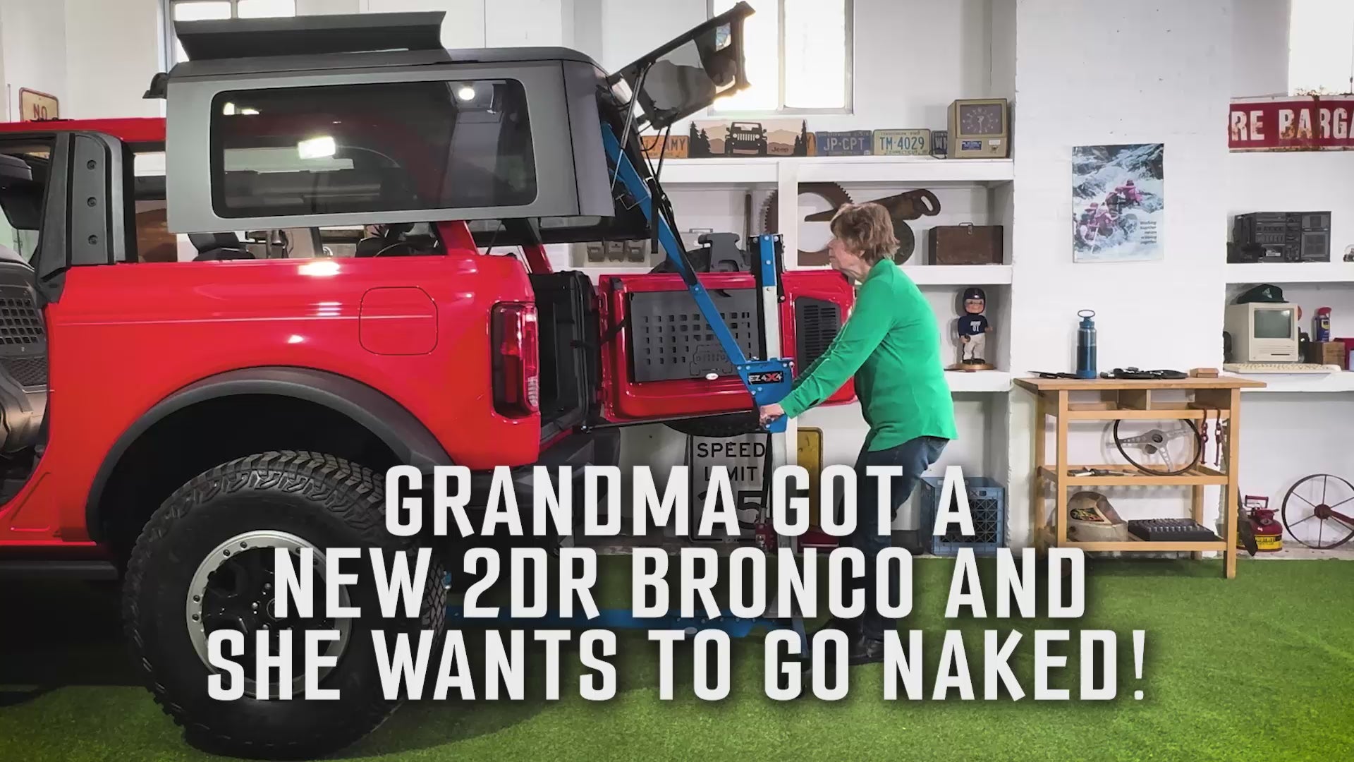 Elderly woman solo removing the hard top of a 2-door red Ford Bronco using the EZ4X4 Hard Top Remover Lift.