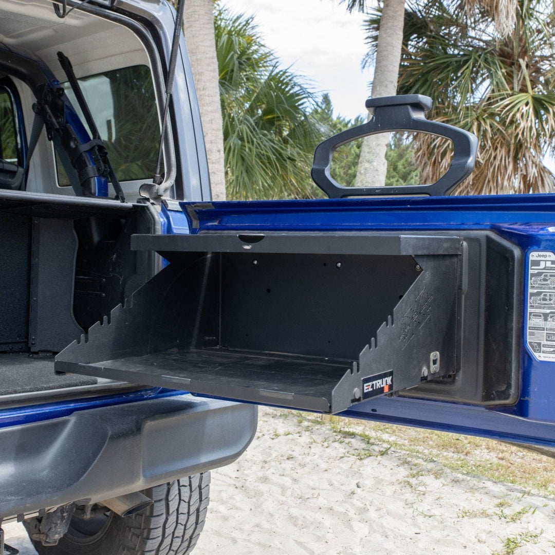Empty Extreme Folding Tailgate Table installed in blue jeep, highlighting design and durable construction.